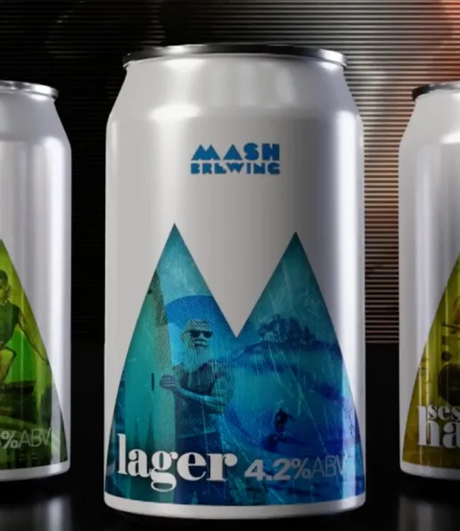 A can of Mash Brewing lager is shown with a blue geometric design and the word lager 4.2% ABV on the front. Partial views of two other craft beer cans with different colours are visible on either side.