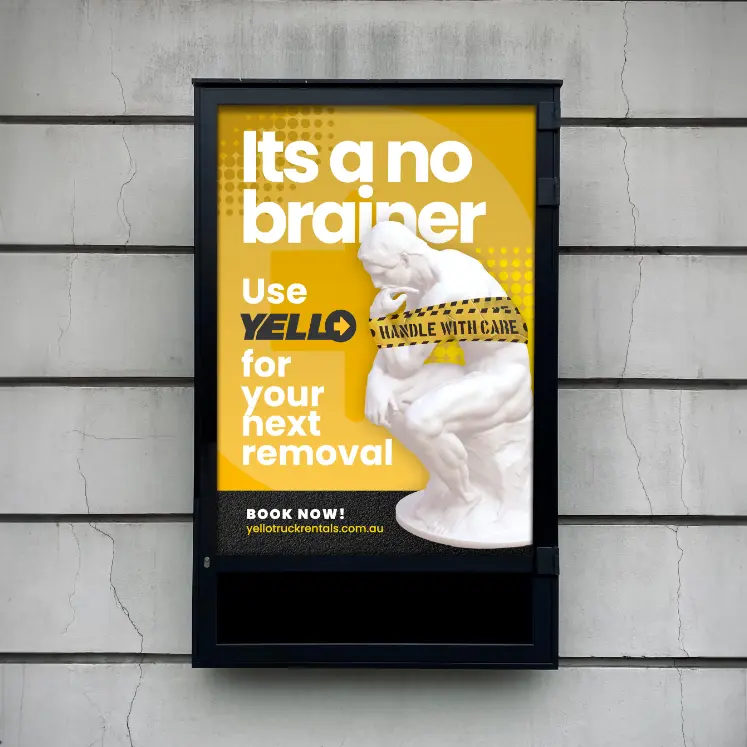 A poster features the statue The Thinker wrapped in Handle with Care tape on a yellow background. Text reads: It’s a no-brainer. Choose Yello Truck Hire for your next removal. Book now! yellotruckrentals.com.au.