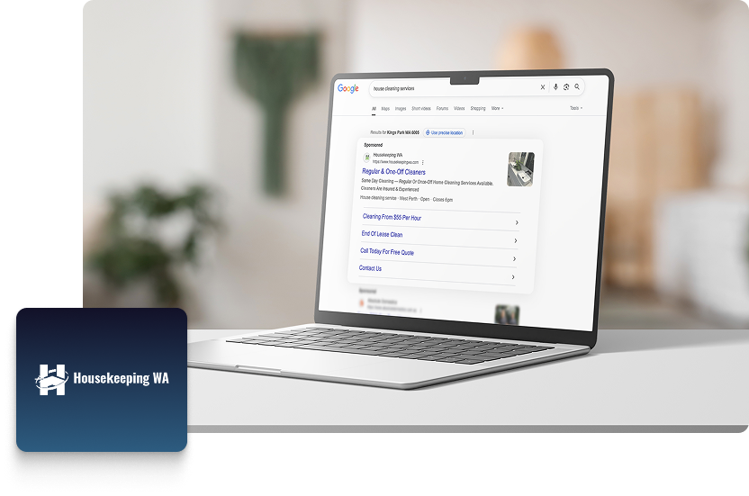 A laptop on a desk displays Google search results for Housekeeping services, highlighting a PPC campaign by Housekeeping WA, with their logo visible in the bottom left corner. The background is softly blurred, suggesting a home environment.