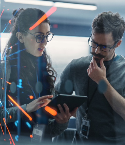 Two people wearing glasses and City Dental ID badges look at a tablet together in a Perth office, with digital data graphics and blue and red light streaks overlaid in the foreground.