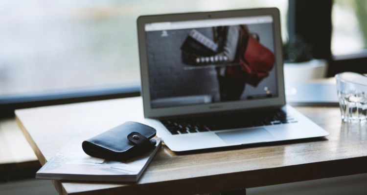 Digital marketing professional conducting email outreach for link building on laptop