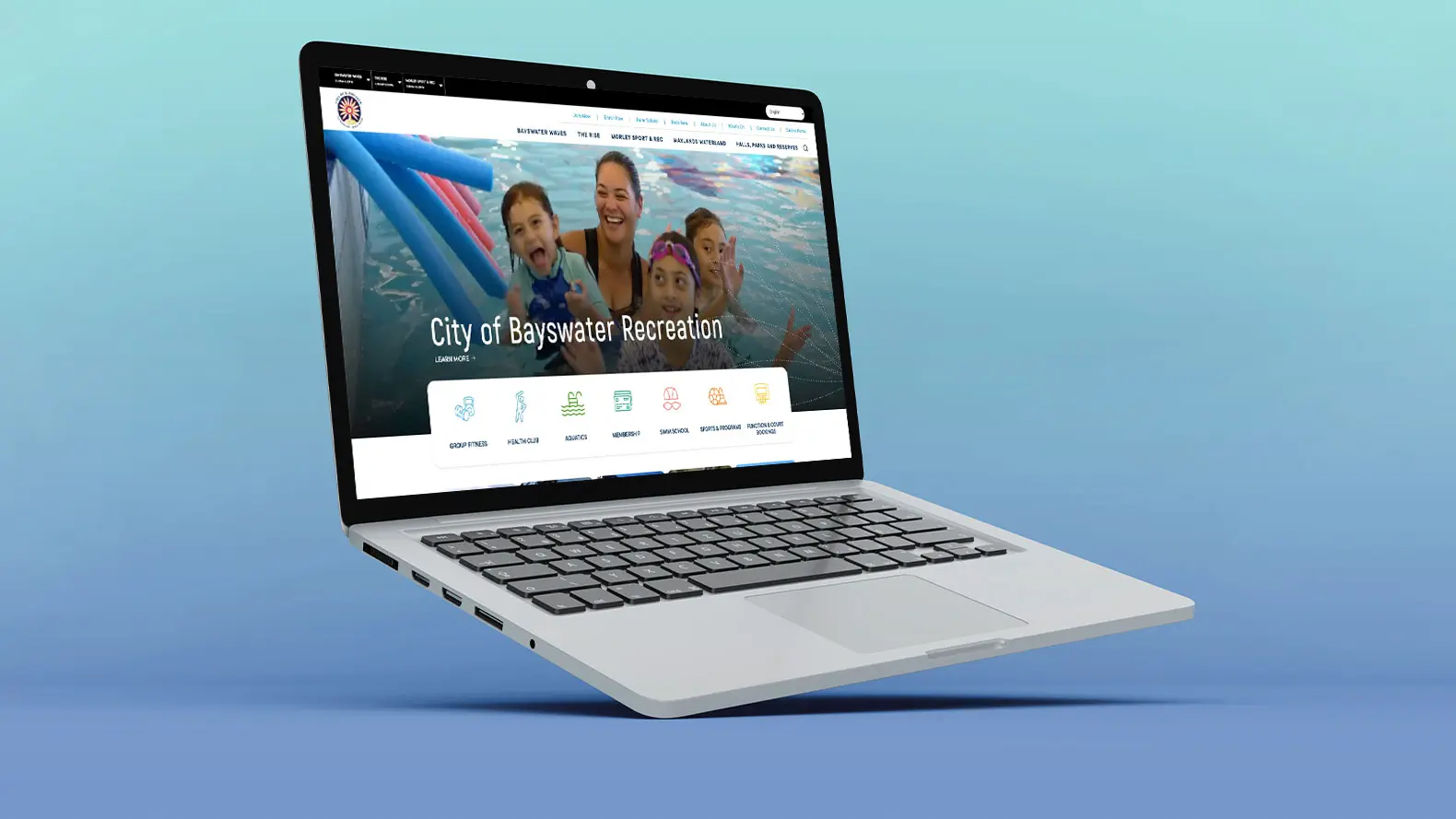 A laptop on a blue gradient background displays the City of Bayswater website, featuring smiling people swimming with pool noodles in the banner image.