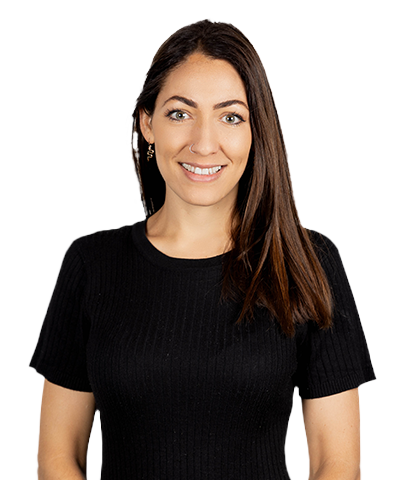 A woman with long brown hair, wearing a black short-sleeve ribbed top, smiling and facing the camera against a plain white background.