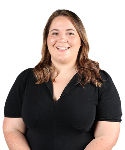 A woman with light brown hair wearing a black dress smiles at the camera against a plain light background.