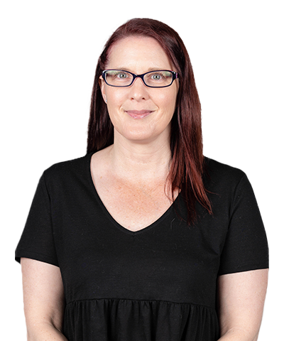Nicola Ridgway, a woman with straight, shoulder-length reddish-brown hair and glasses, smiles at the camera. She is wearing a black short-sleeve top and is posed against a plain light background.
