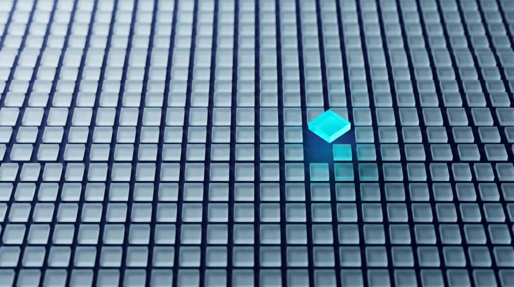 Grid of one thousand small frosted glass tiles on a dark indigo surface with a single cyan-lit tile raised above the rest